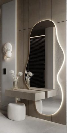 a bathroom with a sink, mirror and vase on the counter in front of it