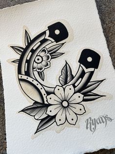 an ink drawing of a tattoo design on white paper with black and grey flowers in the middle