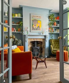 a living room filled with furniture and a fire place next to a doorway that leads to a sitting area