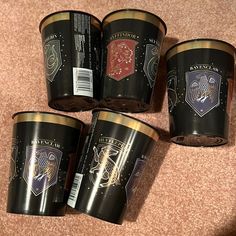 four harry potter mugs sitting on the floor