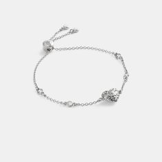 Featuring our quilted Signature heart charm this delicate chain bracelet is embellished with bezel-set crystals for subtle hints of sparkle. It’s finished with an adjustable slide closure marked with our Signature. | Coach Quilted Signature Heart Slider Bracelet - Women's - Silver Slider Bracelet, Delicate Chain, Bezel Setting, Silver Bracelets, Womens Jewelry Bracelets, Heart Charm, Womens Bracelets, Chain Bracelet, Sliders