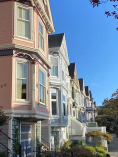 a row of multi - colored houses on a sunny day in san francisco, california