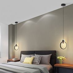 a bed sitting under two lights in a bedroom