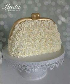 a cake with white frosting and gold decorations