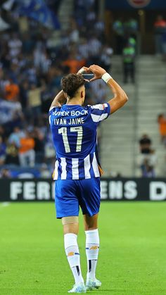 a soccer player saluting to the crowd