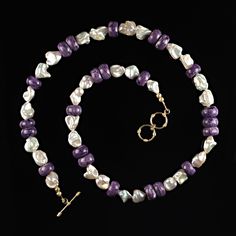 24-25 Inch Expandable Freshwater Pearl and Purple Charoite Necklace Add a touch of elegance and freshness to your wardrobe with this stunning 24-25 inch expandable necklace. Featuring a beautiful mix of creamy white freshwater pearls with unique shapes and smooth purple Charoite rondelles, this piece combines classic luxury with a modern twist. It’s the perfect accessory to wear when you want to feel confident and sophisticated. Key Features: Creamy White Freshwater Pearls: These pearls feature Luxury Lavender Round Beads Necklaces, Charoite Necklace, Interesting Shapes, Classic Pearl Necklace, Iridescent Pearl, Unique Shapes, White Freshwater Pearl, Purple Hues, Unique Necklaces