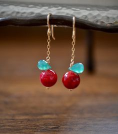 red and turquoise earrings on a wooden table