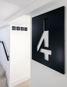 there is a sign on the wall that says 4 and has arrows pointing to different directions