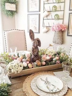 an easter table setting with bunny figurine in centerpiece and flowers on the side