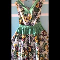 This Dress Is So Beautiful! It Is Hand Made From A Heavy Cotton /Linen With Green Linen Accents At The Waist And The Neck. It Has A Fabulous Floral Print. Pit To Pit, Across The Front Measures 17 Inches. Waist Lying Flat Measures 14 Inches Side To Side.Hips Lying Flat Side To Side Are About 22 Inches. Waist To Him Is 41 Inches. All In Excellent Condition. Such A Great Great Dress To Add To Your Wardrobe Our Collection ! Thank You So Much For Looking. Green Floral Print Dress With Fitted Bodice, Summer Vintage Dress With Fitted Bodice For Garden Party, Green Floral Print Dresses With Fitted Bodice, Green A-line Floral Dress For Garden Party, Green Dresses With Floral Print And Fitted Bodice, Summer Vintage Dress With Fitted Bodice, Green Cotton Party Dress, Summer Vintage Dress With Fitted Bodice And Lining, Multicolor A-line Sundress For Garden Party