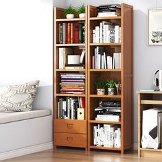 a bookshelf filled with lots of books in a living room next to a couch