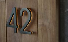 the number twenty four is displayed on a wooden wall