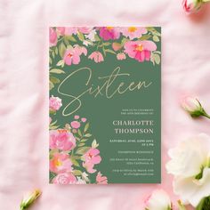 a green and pink floral wedding suite with gold lettering on the front, surrounded by flowers