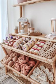 an assortment of cookies and pastries displayed in wicker baskets on a shelf next to a coffee maker