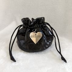 Vintage Guess Pouch. Store Your Jewelry In This Beautiful Pouch . Features Quilted, Patent Design, Drawstring Closure And A Silver Engraved Logo Heart Pendant. Approximate Measurements 5"(W) X 4"(H). Never Used Trendy Pouch With Dust Bag As Gift, Trendy Black Pouch Coin Purse, Trendy Black Coin Purse For Personal Use, Trendy Black Pouch For Personal Use, Black Pouch Cosmetic Bag Gift, Bags Guess, Logo Heart, Guess Bags, Engraved Logo