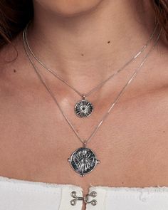 Our best-selling double coin charm necklace with embossed evil eye design Sold as a set of 2 necklaces- Necklaces are NOT connected and can be worn separately Chains are 16" and 18", both with 2" of extender chain Smaller charm is 0.65" (16.6 mm) Larger charm is 0.92" (23.5mm) Made From Brass with Swarovski Crystals Plating is 0.03 microns + e-coating for long lasting durability Plated high polish Rhodium for maximum shine Both chains have a lobster clasp closure Necklace is 100% nickel-free and Silver Charm Necklace With Adjustable Coin Chain, Silver Charm Necklace With Coin And Adjustable Chain, Silver Charm Necklace With Coin Pendant For Layering, Silver Tarnish Resistant Charm Necklace For Layering, Silver Coin Pendant Jewelry For Layering, Silver Charm Necklaces With Coin Pendant, Silver Coin Pendant Necklace For Layering, Silver Necklace With Coin Pendant For Layering, Silver Tarnish Resistant Round Disc Coin Necklace