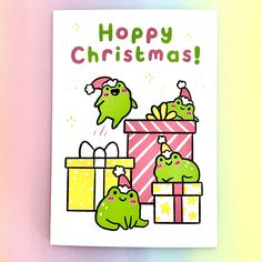 a christmas card with two green monsters opening gifts and the words happy christmas written on it