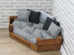 a couch made out of wooden crates with pillows on it and the words dogs name