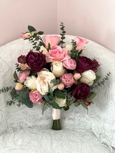 a bouquet of flowers sitting on top of a white chair