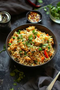 a bowl filled with rice and vegetables on top of a table