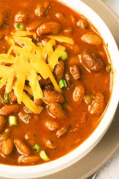 a white bowl filled with beans and cheese