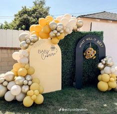 an outdoor area with balloons and decorations for a baby shower or birthday party in gold, silver and white