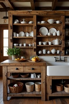 a kitchen filled with lots of wooden shelves next to a white sink and counter top