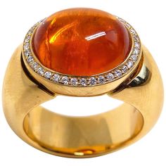 Thomas Leyser is renowned for his contemporary jewellery designs utilizing fine gemstones. This 18k rose gold ring (29.15g) is set with 1x fine Mandarine Garnet Cabouchon (oval, 14x12mm, 12.15ct) + 36x Diamonds (brillant-cut, 1mm, G/VS). Ringsize 7.5 (56). Rose Gold Cufflinks, Garnet And Diamond Ring, Contemporary Jewelry Design, Solitaire Rings, Gold Cufflinks, Contemporary Jewellery, Jewellery Designs, Cocktail Rings, Solitaire Ring