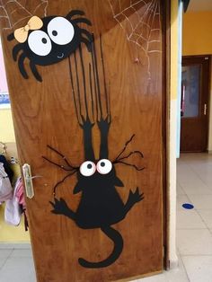 a door decorated with an image of a spider and a cat on it's face