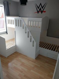 a white bunk bed sitting next to a window in a child's room with wooden floors