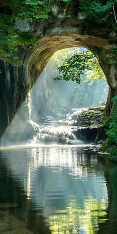 there is a waterfall in the middle of a river with water coming out of it