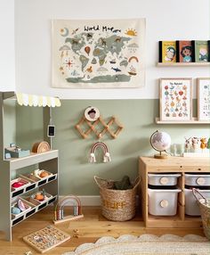 a child's playroom with toys, bookshelves and other items on the wall