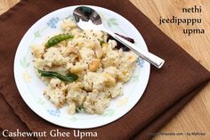 a white plate topped with mashed cauliflower and green beans next to a brown napkin