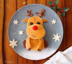 a plate that has some kind of cake on it with icing and snowflakes