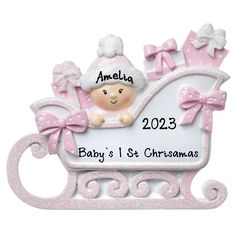 a baby's first christmas ornament in pink and white