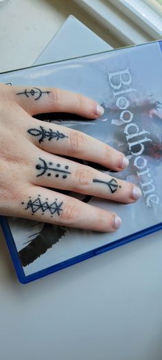 a woman's hand with tattoos on it