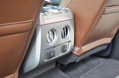 the interior of a car with tan leather and gray carpeting, including an automatic gear box