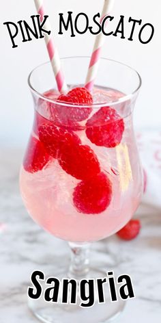 pink moscato sangria in a glass with strawberries on top and the words, pink moscato sangria above it