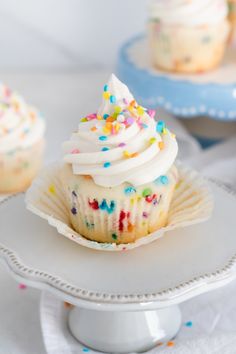 cupcakes with white frosting and colorful sprinkles