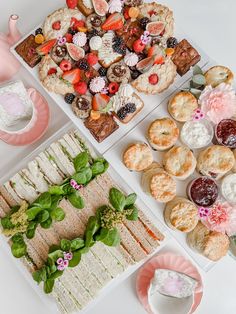 a table topped with lots of different types of desserts and pastries next to each other