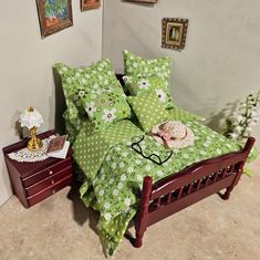 a bed with green and white polka dot sheets