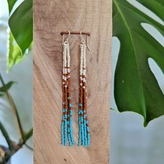 "Embrace your inner bohemian goddess with our fan favorite long fringe beaded earrings - but in a more glossy finish bead (compared to the usual matte beads that I use). Beautifully dramatic, comfortably lightweight. Enjoy the playful, free flowing style of beaded fringe earrings, without the weight.  Featuring 4 strands of hand woven matte glass beads. These unique matte glass beads have a very luxe look and feel to them.  Colors: These beaded earrings feature an ombre fade of matte ivory, rust & turquoise glass beads. Length: Approximately 4\" drop length Metal: 14K Gold Filled or Sterling Silver (Gold-filled jewelry has 100x more gold alloy than gold plated and because that layer is so much thicker, it means gold-filled jewelry lasts longer and stands up to wear and tear better than gol Hand-strung Dangle Earrings For Festivals, Bohemian Long Drop Beaded Earrings With Dangling Beads, Bohemian Long Drop Earrings With Dangling Beads, Bohemian Long Drop Chandelier Earrings With Dangling Beads, Bohemian Adjustable Tassel Earrings With Dangling Beads, Bohemian Beaded Dangle Earrings With Tassels, Bohemian Tassel Earrings With Beaded Fringe, Adjustable Bohemian Beaded Earrings With Tassels, Bohemian Beaded Earrings With Tassels