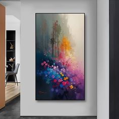 an abstract painting hangs on the wall next to a dining room table with chairs in it