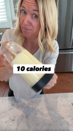 a woman is pouring some liquid into a blender with the words 10 calories on it