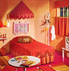 a bedroom decorated in pink and orange with a red bed spread on the floor next to a white coffee table