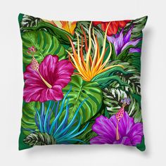 a pillow with colorful tropical flowers and leaves on the front, along with green foliage