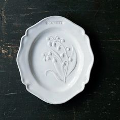 a white plate sitting on top of a wooden table