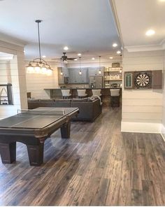 a living room filled with furniture and a ping pong table