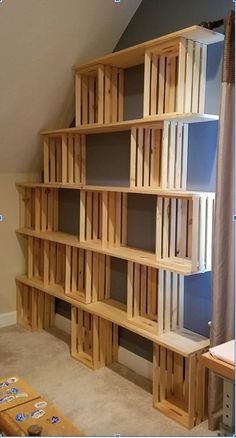 a wooden book shelf sitting in the corner of a room