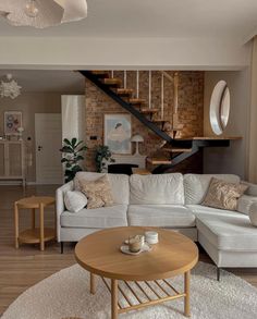 a living room filled with furniture and a spiral staircase